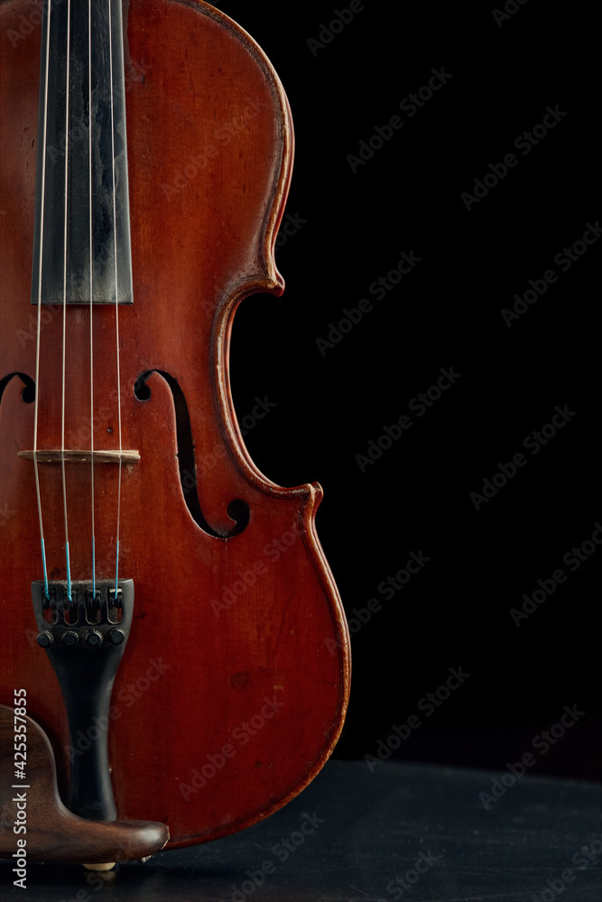 Brown wooden violin in retro style, closeup view Brown wooden violin in retro style, closeup view