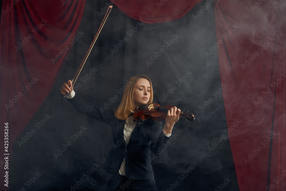 Female violonist with bow and violin, solo concert