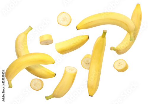 Whole bananas and slices are flying on a white background. Isolated