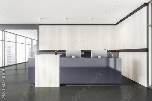 Grey and white wooden reception room interior with computers on marble floor