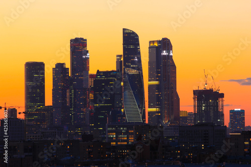 Sunset landscape with Moscow City silhouettes and the orange sky background.