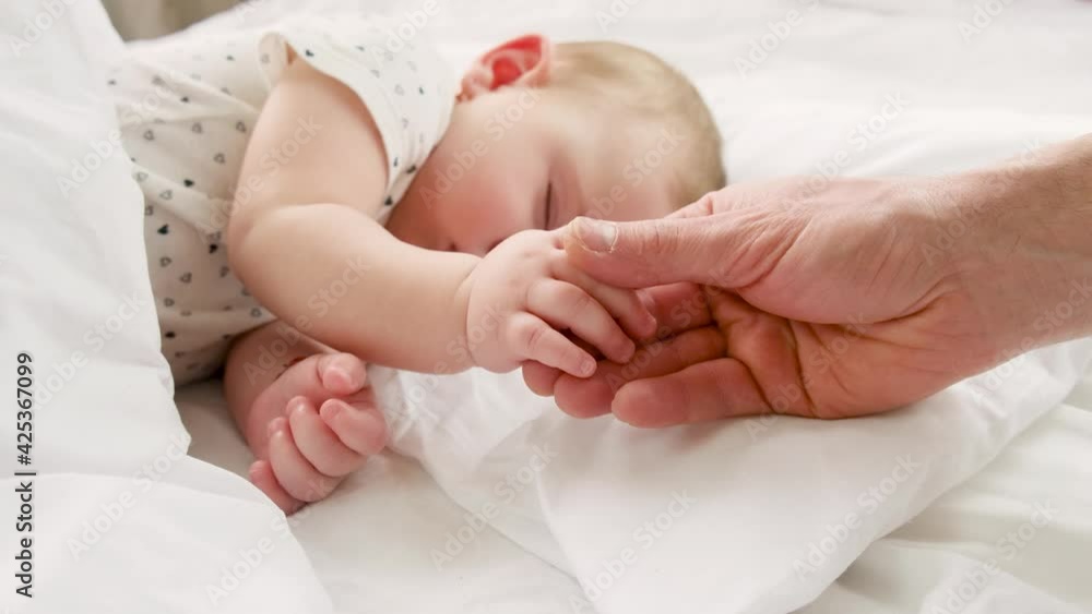 Little baby sleeping father gives by the hand. selective focus. Little baby sleeping father gives by the hand. selective focus.