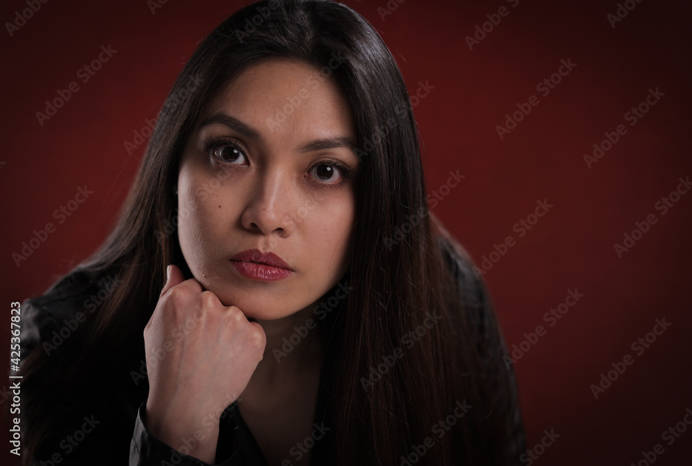 Young thoughtful woman in close-up - studio photography Young thoughtful woman in close-up - studio photography