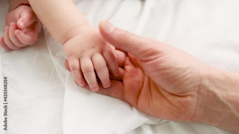 Little baby sleeping father gives by the hand. selective focus. Little baby sleeping father gives by the hand. selective focus.