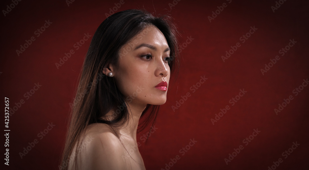 Sexy close-up of a young Asian woman with bare shoulder - studio photography