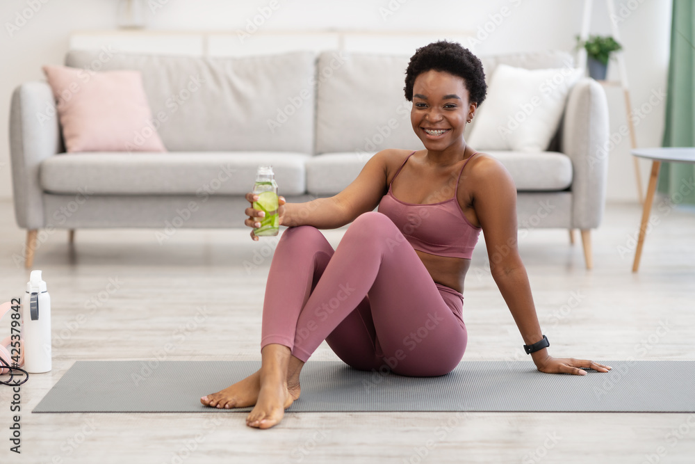 Black Lady Holding Water Bottle Hydrating During Training At Home