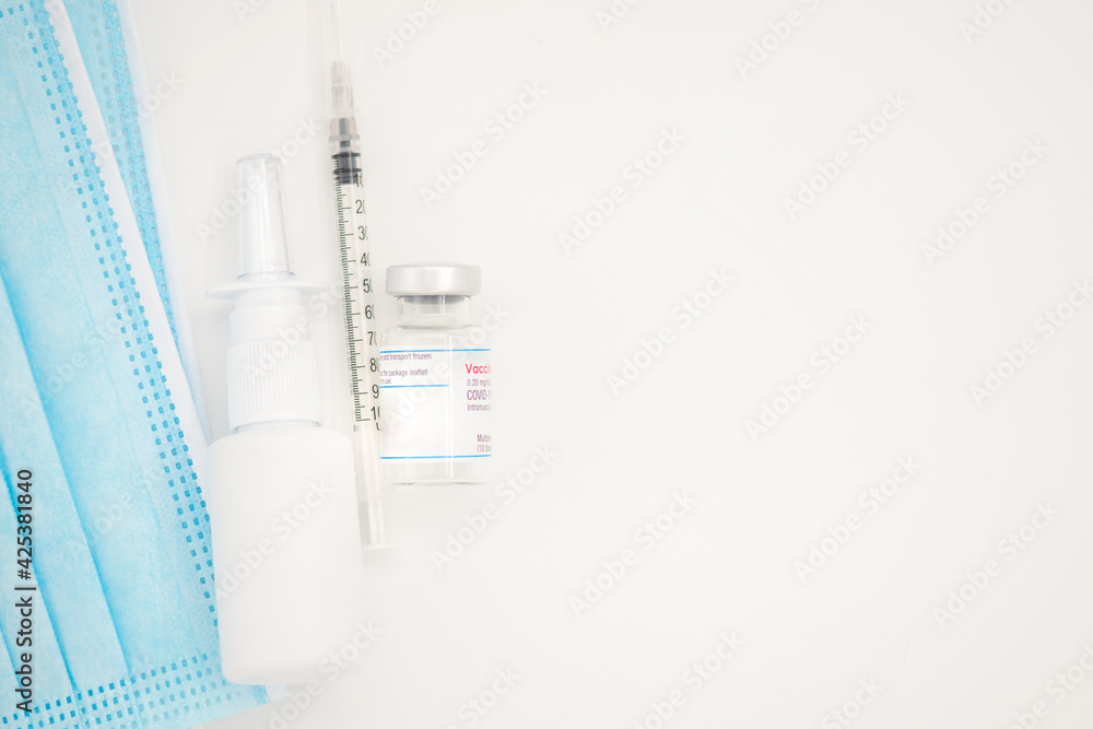 Protective mask, immune vaccine and container with nasal anti-covid treatment isolated on white