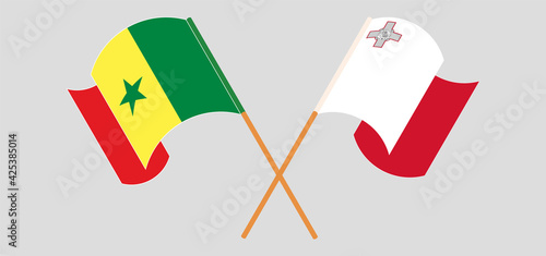 Crossed and waving flags of Senegal and Malta