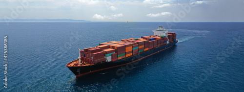 Aerial drone panoramic ultra wide photo of industrial container tanker ship cruising in open ocean deep blue sea