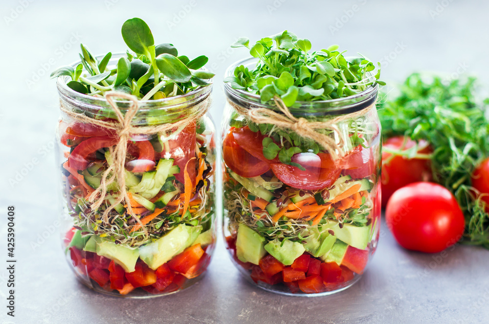Vegetables salad in open jar Tomato, avocado,pepper, cucumber, micro greens Healthy food, diet, clean food and vegetarian concept Vegetables salad in open jar Tomato, avocado,pepper, cucumber, micro greens Healthy food, diet, clean food and vegetarian concept