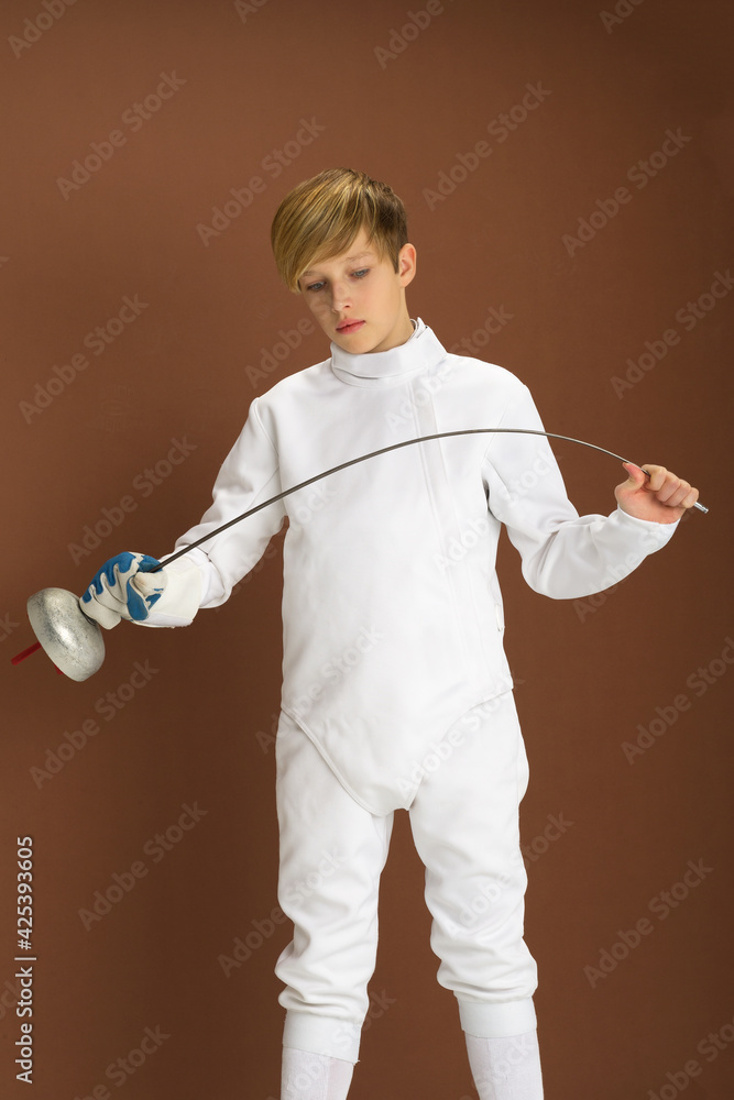Boy fencer in white fencing costume with rapier Stock Photo | Adobe Stock