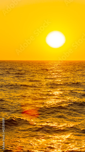Orange sunset over sea. Bright sun over the sea horizon. Concept: vacation, relax, romantic