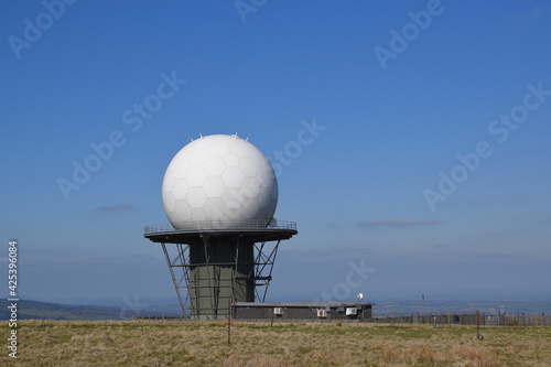 a view of the radar station at Titterstone Clee summit with the sky clear blue