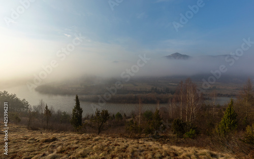 Sunrise over the mountains shrouded in fog. Landscape of the mountain river Stryi, Carpathian mountains, Ukraine, Europe. Carpathian mountains, Beskydy region view of the valley of the river Stryi.