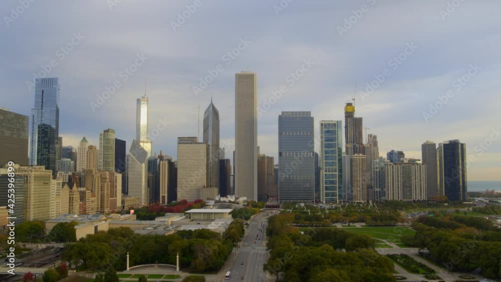 Aerial of Chicago skyline, park and traffic moving on street Aerial of Chicago skyline, park and traffic moving on street
