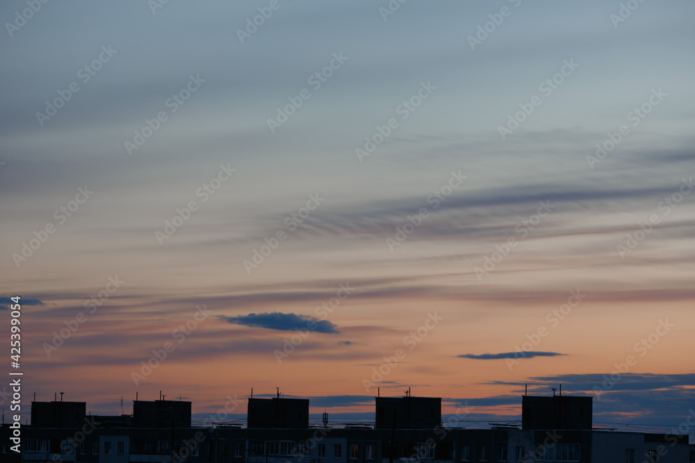 Sunset sky against the background of city houses. Sunset sky against the background of city houses.