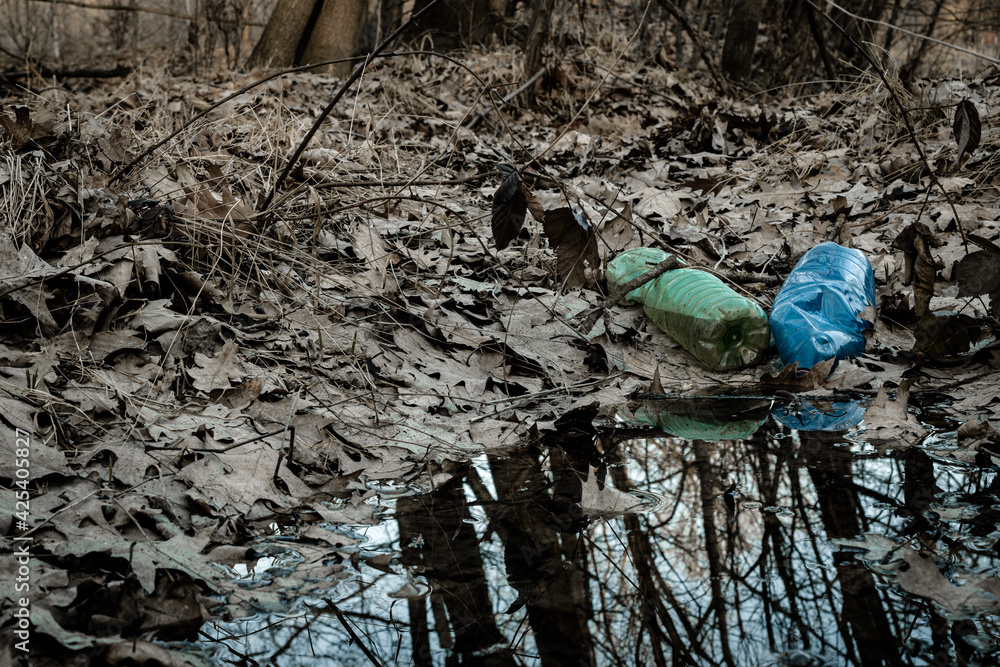 Environment and plastic garbage in woodland. Rubbish trash, waste in forest. Ecological problem with Empty used bottles of big city. Environment and plastic garbage in woodland. Rubbish trash, waste in forest. Ecological problem with Empty used bottles of big city.