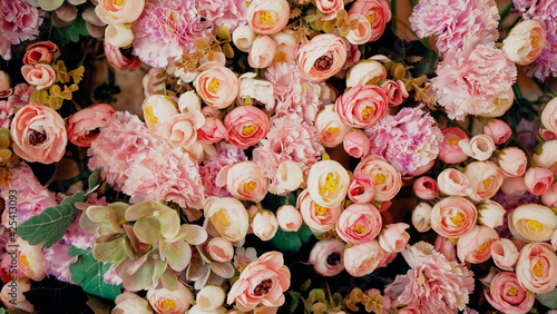 Texture a bouquet of different plant petals. A lot of sea of flowers, roses, peonies, carnations. The concept of flowering in spring and summer.