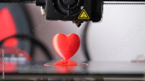 3D printer printing a red heart