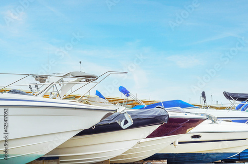Boats on stand on the shore, luxury yachts and ships, maintenance and parking place boat