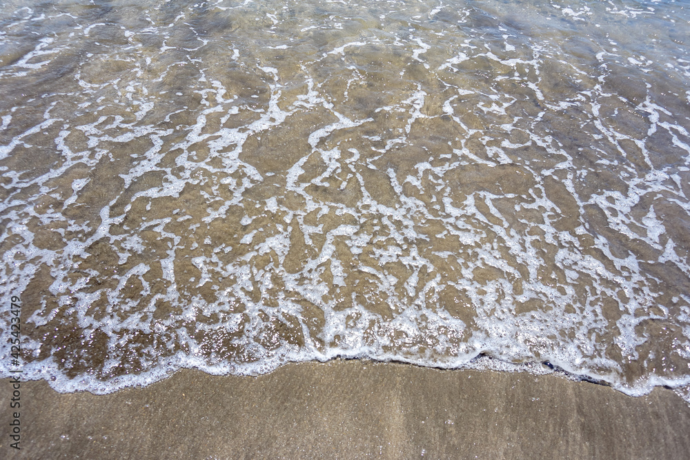 Sand and waves on the beach with empty space for text. Sand and waves on the beach with empty space for text.