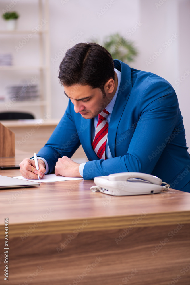 Young businessman employee working in the office Young businessman employee working in the office