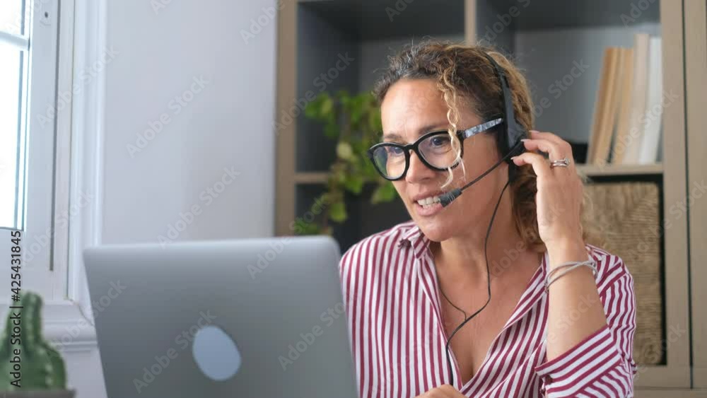 Attractive caucasian woman sit at home office room wearing headset take part in educational webinar using laptop. Video call event with clients or personal chat with friend remotely concept
Attractive caucasian woman sit at home office room wearing headset take part in educational webinar using laptop. Video call event with clients or personal chat with friend remotely concept