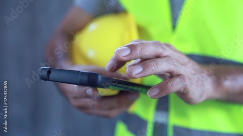 Close up construction worker touch screen on smart phone