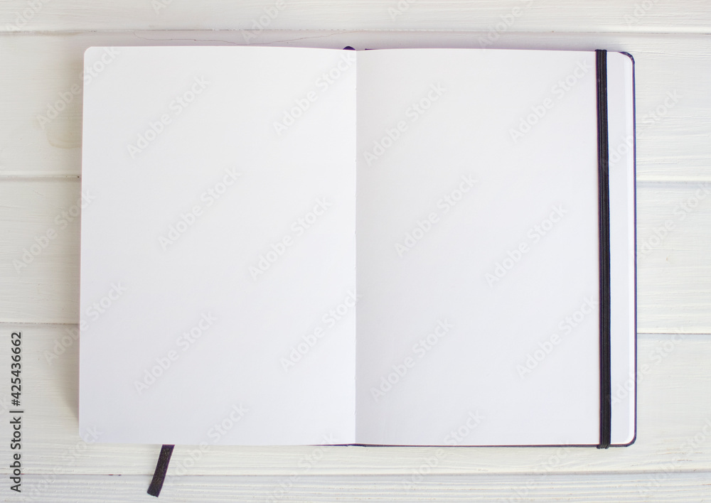 White empty sketchbook pages on white wood White empty sketchbook pages on white wood