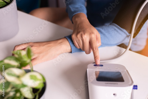 Hands woman using blood pressure & heart rate monitors in yourself at home