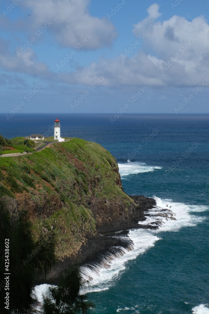 A lighthouse stands against the Pacific on the island of Kauai