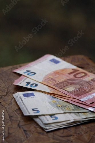 stacked european banknotes of different denomination on the brown table
