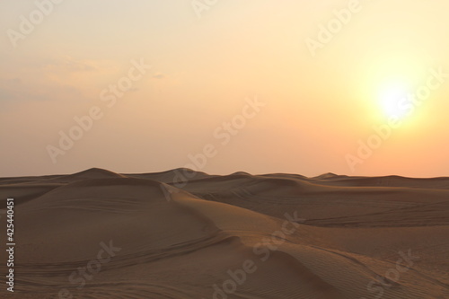 Fototapeta Naklejka Na Ścianę i Meble -  Little girl looking at the Sunset at Dubai's Desert by Christian Gintner