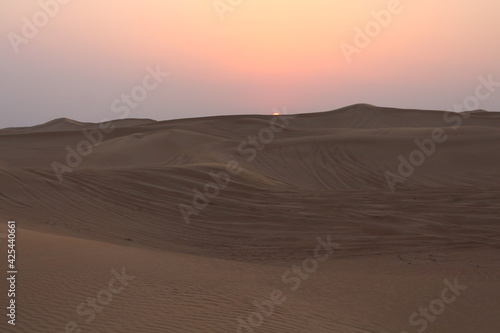 Little girl looking at the Sunset at Dubai s Desert by Christian Gintner