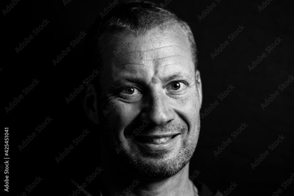 Portrait headshot of handsome white male on dark background