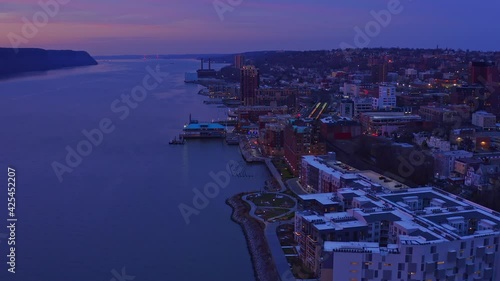 Aerial forward over Yonkers town and Hudson river during blue hour, New York