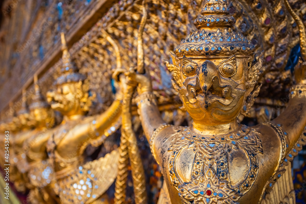Details on the base of the Wat Phra Kaew's main hall - a sacred temple whic is a part of the Thai grand palace, where it houses an ancient Emerald Buddha Details on the base of the Wat Phra Kaew's main hall - a sacred temple whic is a part of the Thai grand palace, where it houses an ancient Emerald Buddha