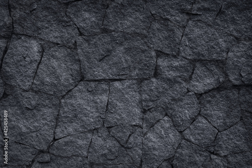 Dark grey slate stone or black stone wall texture background © modify260