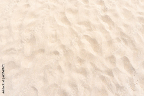 sand texture in sunny summer sun. Wallpaper and background concept.