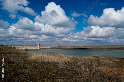 Reservoir Crimea, Mezhgornoye. Beautiful landscape with a view of the reservoir, lake, clouds, water tower.