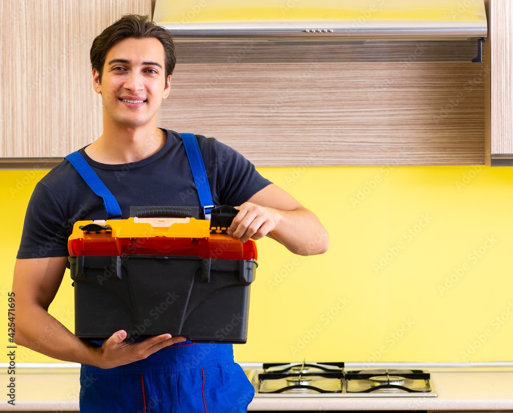 Young service contractor assembling kitchen furniture Young service contractor assembling kitchen furniture