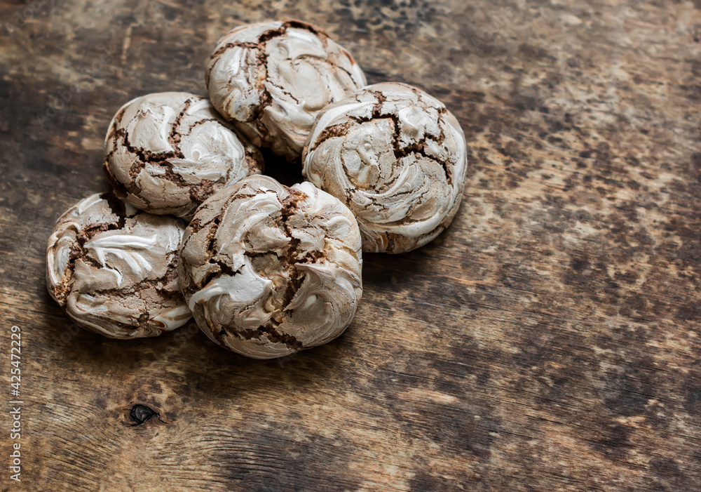 Fototapeta premium Chocolate meringue on a wooden background, top view. Copy space