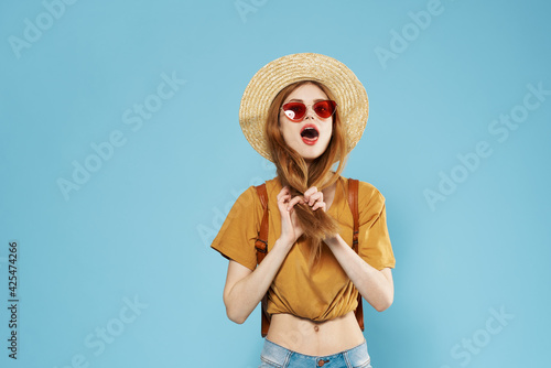 Beautiful woman in hat dark glasses fashionable clothes emotions studio cropped view fun model