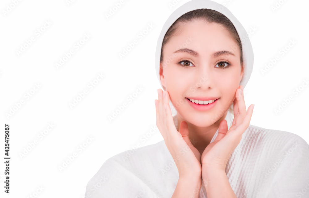 Portrait of beautiful asian woman touching face by hands finger after clean fresh skin on face. Happy young lady in white dress with towel from skin care treatment in beauty clinic. White background. Portrait of beautiful asian woman touching face by hands finger after clean fresh skin on face. Happy young lady in white dress with towel from skin care treatment in beauty clinic. White background.