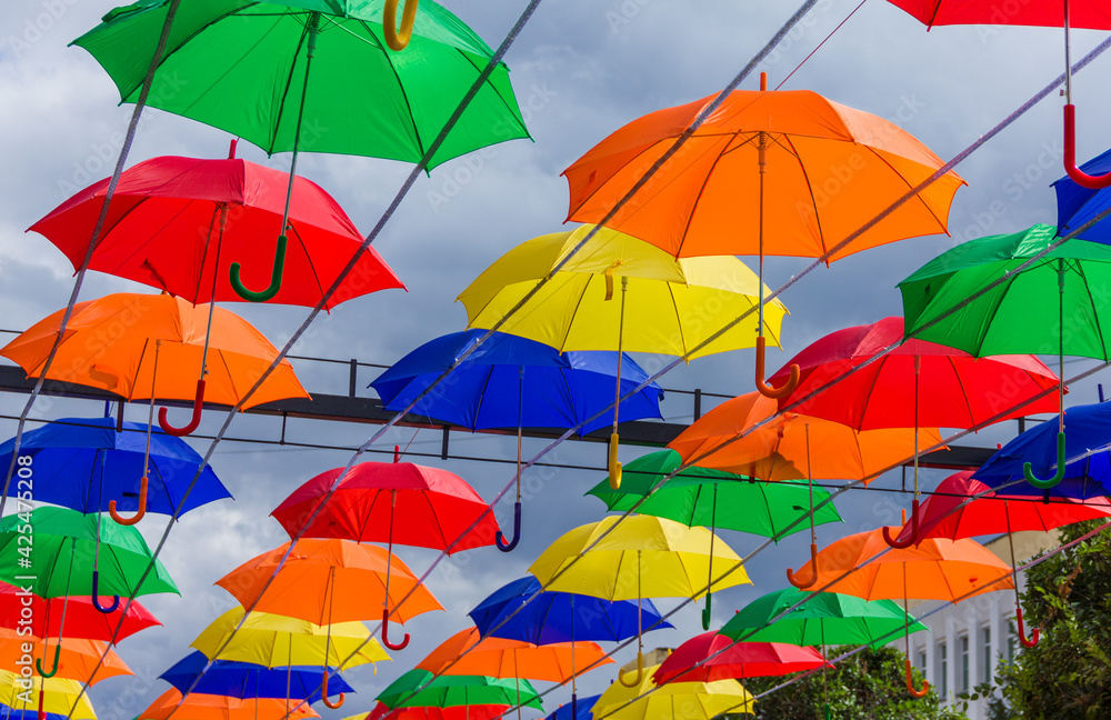 Beautiful colorful umbrellas. Street decoration with umbrellas. Lots of colorful umbrellas in the central square.