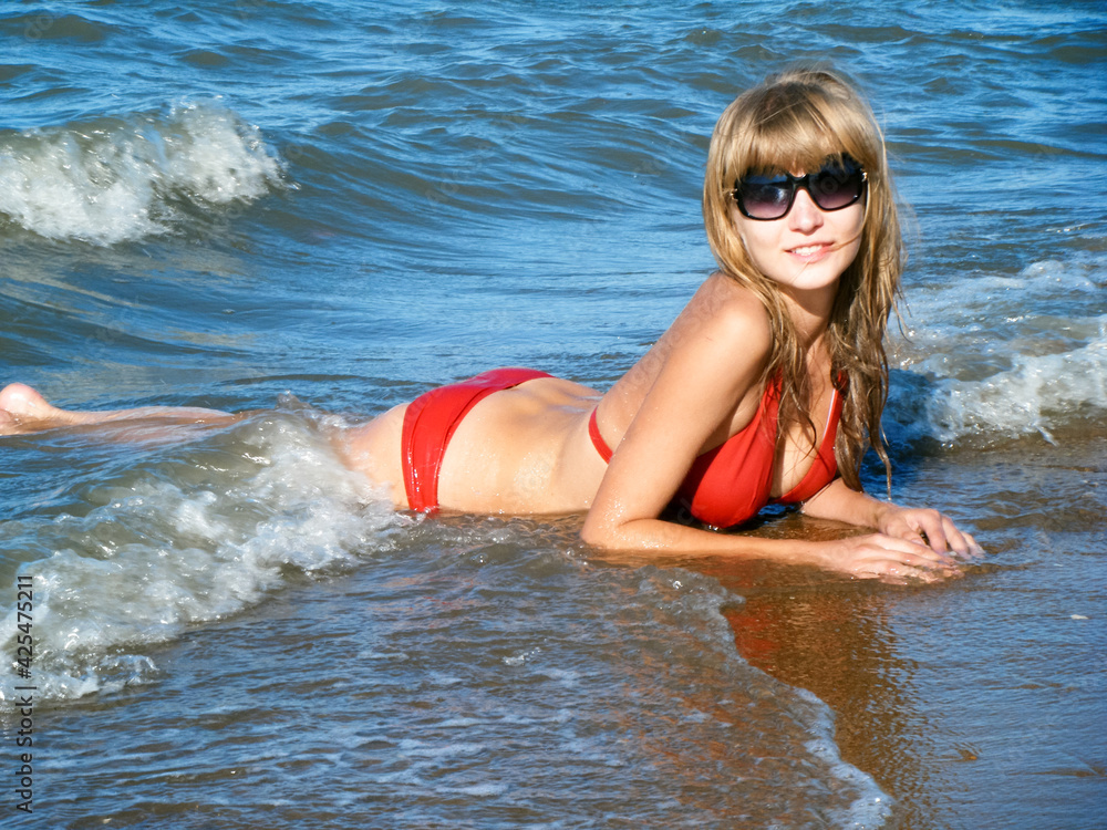 Beautiful Girl in a swimsuit in the sea. Marine Landscape