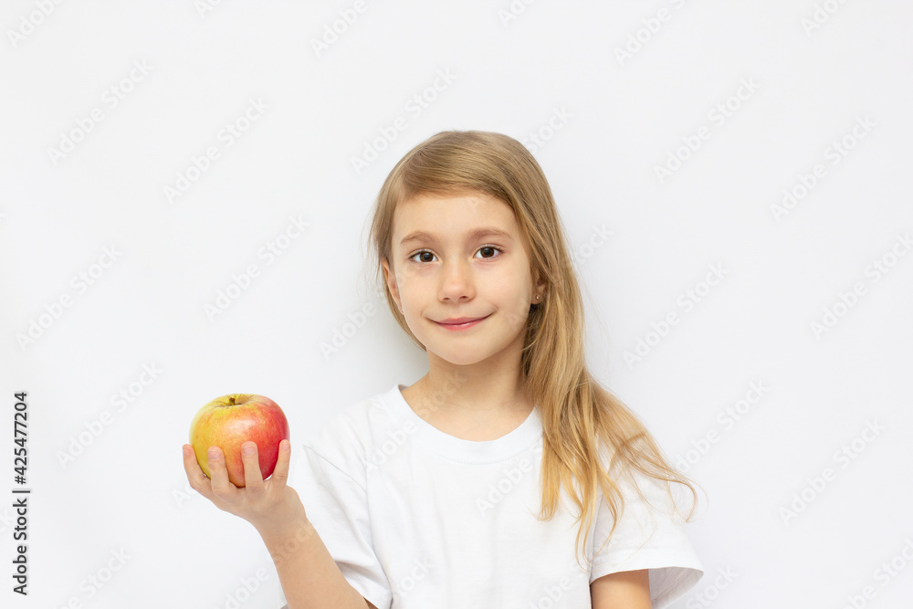 Portrait of cute little girl holding an apple - isolated on white. Portrait of cute little girl holding an apple - isolated on white.