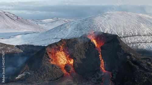 New spatter cone volcano in remote Iceland landscape spewing lava photo