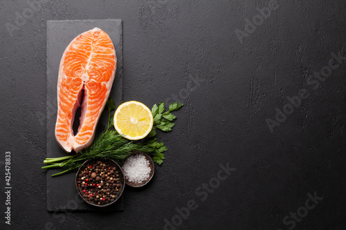 Fresh raw salmon cooking. Fish steak with herbs and spices