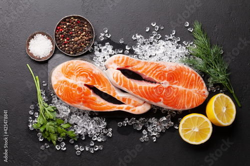 Fresh raw salmon cooking. Fish steaks with herbs and spices